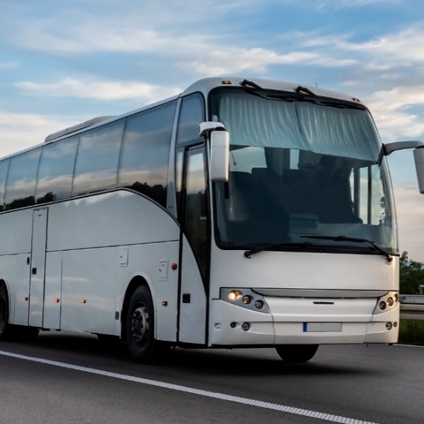 Image of a tour bus driving down the highway.